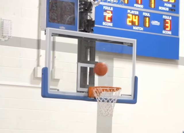 Picture of a basketball going into a basket.