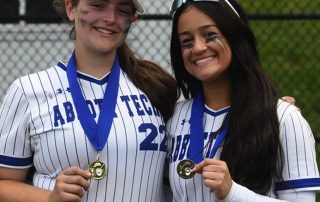 Abbott student softball players wearing medals.
